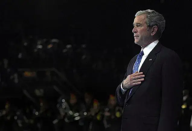 President George W. Bush places his hand on his heart while the national anthem plays during the Armed Forces Full Honor Farewell to President George W. Bush on Fort Myer, Va., Jan. 6, 2009. CC BY 2.0. United States, 2009. President George W. Bush places his hand on his heart while the national anthem plays during the Armed Forces Full Honor Farewell to President George W. Bush on Fort Myer, Va., Jan. 6, 2009. CC BY 2.0. United States, 2009.