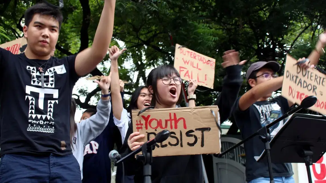 Shibby de Guzman, 13, center, joins other youths Tuesday at a Manila rally to protest policies of the Duterte government. Image by Ana P. Santos. Philippines, 2017.