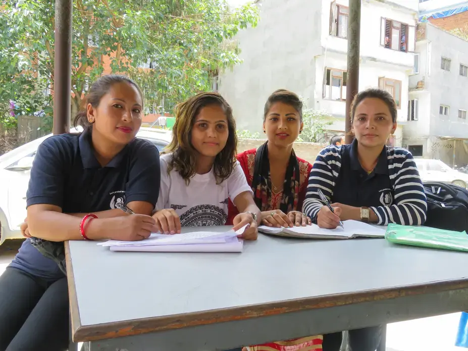 Survivors and certified paralegals Renuka, Bidhya, Apsara, and Santa work in a Kathmandu police station filing criminal complaints. Image by Nicole Brigstock. Nepal, 2018. Survivors and certified paralegals Renuka, Bidhya, Apsara, and Santa work in a Kathmandu police station filing criminal complaints. Image by Nicole Brigstock. Nepal, 2018.