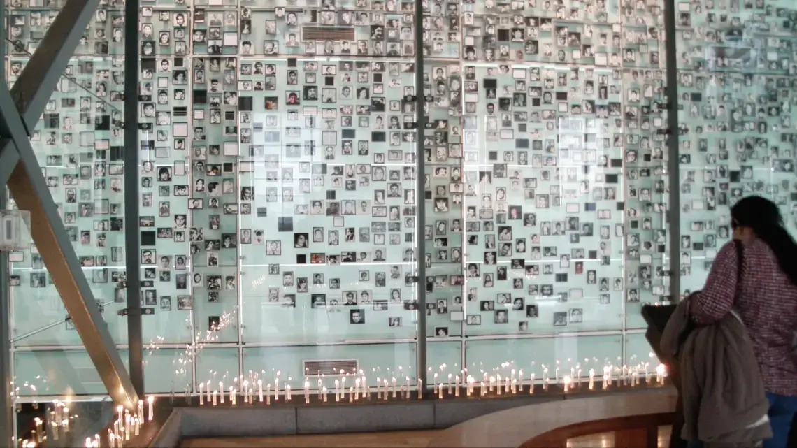 A wall with photographs of those who victims of the Pinochet regime.