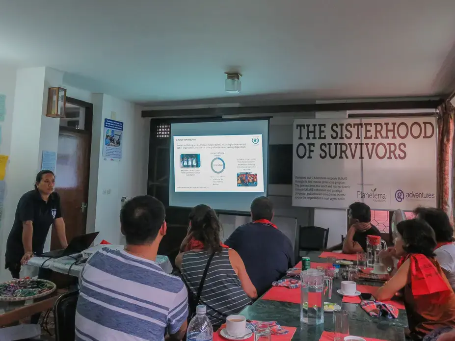 Indira Gurung, co-founder of NGO Samrakshak Samuha Nepal, discusses human trafficking in Nepal to a group of travelers. Image by Nicole Brigstock. Nepal, 2018. Indira Gurung, co-founder of NGO Samrakshak Samuha Nepal, discusses human trafficking in Nepal to a group of travelers. Image by Nicole Brigstock. Nepal, 2018.