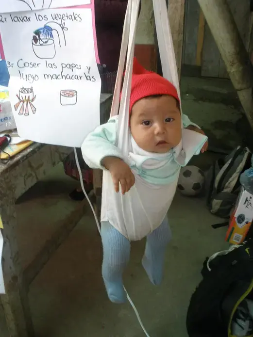 Weighing-in. A baby is weighed during the Primeros Pasos cooking demonstration in Chuicavioc, Guatemala. Image by Anne Thurow. Guatemala, 2013. Media file: 2013-07-09_18.28.27.jpg