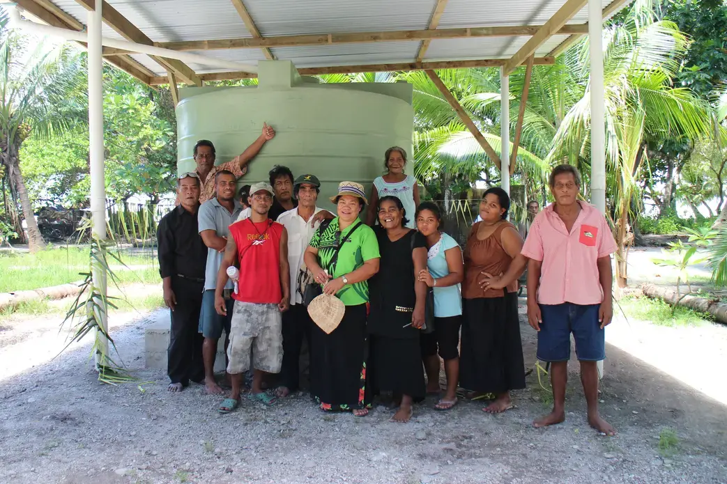 Buariki Village leaders and Professor Pelenise Alofa (center), in front of a newly completed rainwater tank. Image by Janice Cantieri. Kiribati, 2014. Buariki Village leaders and Professor Pelenise Alofa (center), in front of a newly completed rainwater tank. Image by Janice Cantieri. Kiribati, 2014.