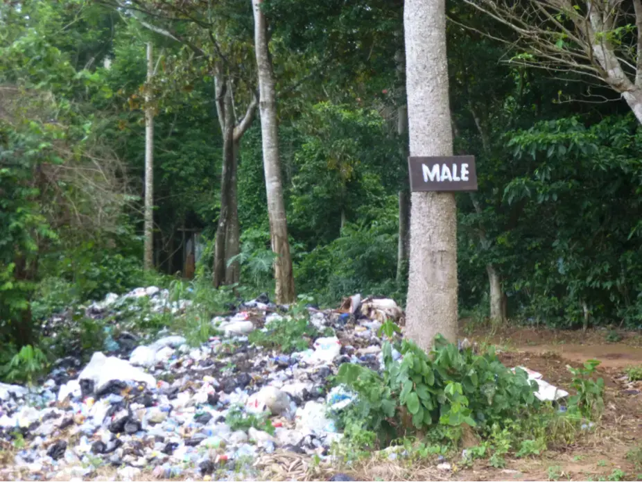 A church camp dumps its waste in the forested mountains.
Close by is what appears to be an open-air male toilet. Image by Diksha Bali. Ghana, 2013. Media file: church_state_waste_db.png