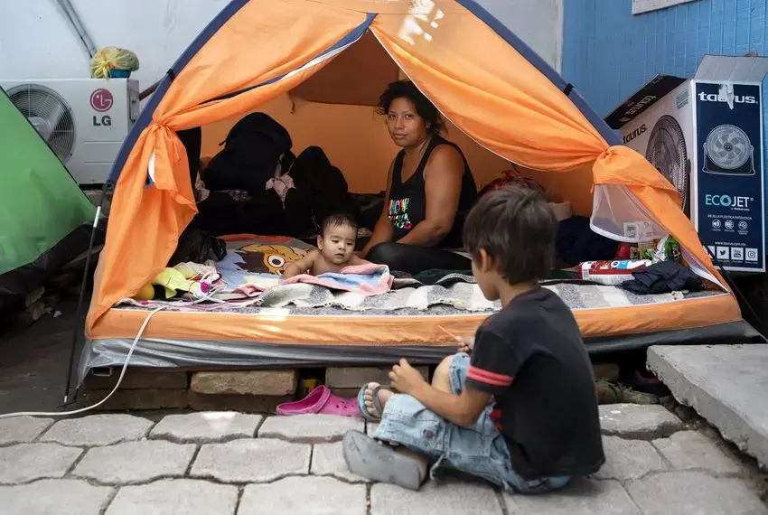 Vanessa Ramos Chavez rested in a tent at Senda de Vida migrant shelter in Reynosa, Mexico, on Saturday. She said she arrived at the shelter from El Salvador more than a month ago with her infant son, Anderson Josue. Image by Miguel Gutierrez Jr. Mexico, 2019.