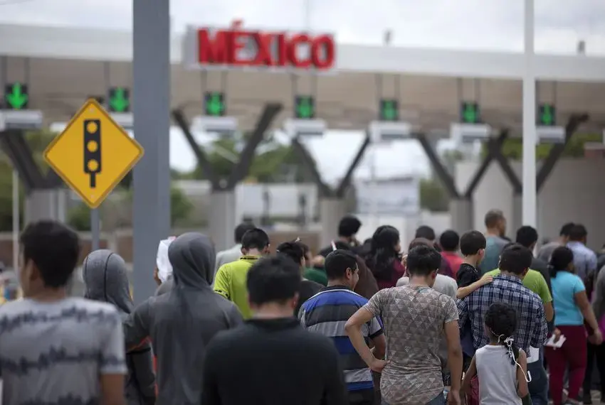 Migrants walk across International Bridge Two into Nuevo Laredo from Laredo. They requested asylum in the United States but were returned to Mexico to await their court proceedings. Image by Miguel Gutierrez Jr. United States, 2019. Migrants walk across International Bridge Two into Nuevo Laredo from Laredo. They requested asylum in the United States but were returned to Mexico to await their court proceedings. Image by Miguel Gutierrez Jr. United States, 2019.