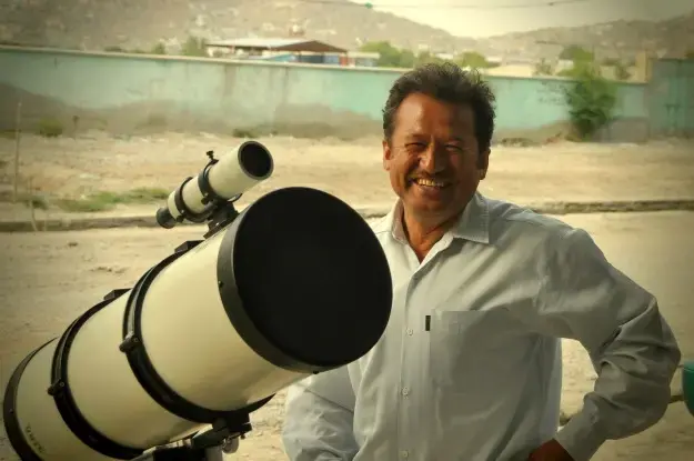 Yunos Bakshi standing with one of his telescopes in Kabul, Afghanistan. Bakshi is the founder of Afghanistan's first Astronomy Association. Image by Jeffrey E. Stern. Afghanistan, 2013. Media file: stargazer.jpg