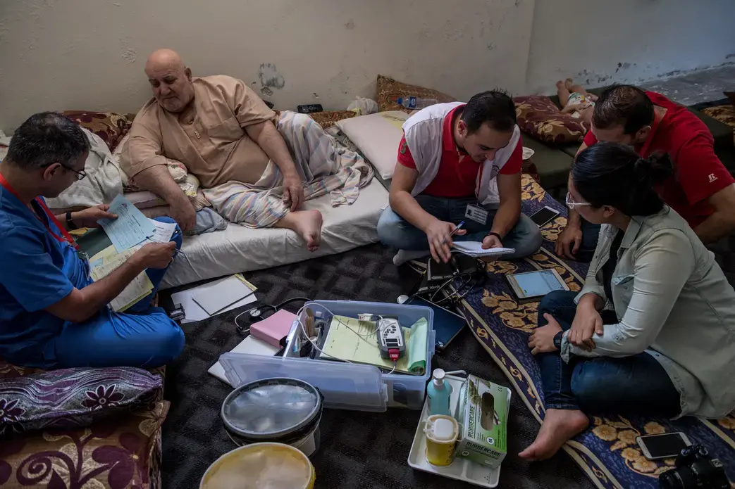 A doctor from Médecins Sans Frontières speaks with Ibrahim Hassan, a Syrian refugee living in Northern Jordan. Staff from the Dharma Platform collect information and prepare to deploy new data-collection technology along the Syrian border. Image by Neil Brandvold. Jordan, 2017. A doctor from Médecins Sans Frontières speaks with Ibrahim Hassan, a Syrian refugee living in Northern Jordan. Staff from the Dharma Platform collect information and prepare to deploy new data-collection technology along the Syrian border. Image by Neil Brandvold. Jordan, 2017.