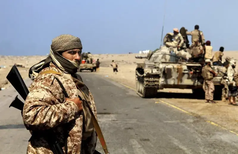 Coalition-backed fighters advance on Yemen’s Red Sea port town of Mocha in this Jan. 11 2017, photo. The coalition forces eventually captured the town from Shiite rebels known as Houthis. Some fighters in the unit were openly al-Qaida, wearing Afghan-style garb and carrying weapons with an al-Qaida logo, a sign of how closely the militants have been involved in the war against the Houthis, who are seen by Saudi Arabia and the United Arab Emirates as a proxy for Iranian influence. Image by AP. Yemen, 2017. Coalition-backed fighters advance on Yemen’s Red Sea port town of Mocha in this Jan. 11 2017, photo. The coalition forces eventually captured the town from Shiite rebels known as Houthis. Some fighters in the unit were openly al-Qaida, wearing Afghan-style garb and carrying weapons with an al-Qaida logo, a sign of how closely the militants have been involved in the war against the Houthis, who are seen by Saudi Arabia and the United Arab Emirates as a proxy for Iranian influence. Image by AP. Yemen, 2017.