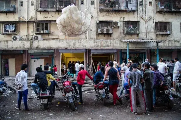 Dharavi residents gather around a sculptural installation outside the Shama Building. Image by Matthew Niederhauser. India, 2015. Media file: c3f0df39a.jpg