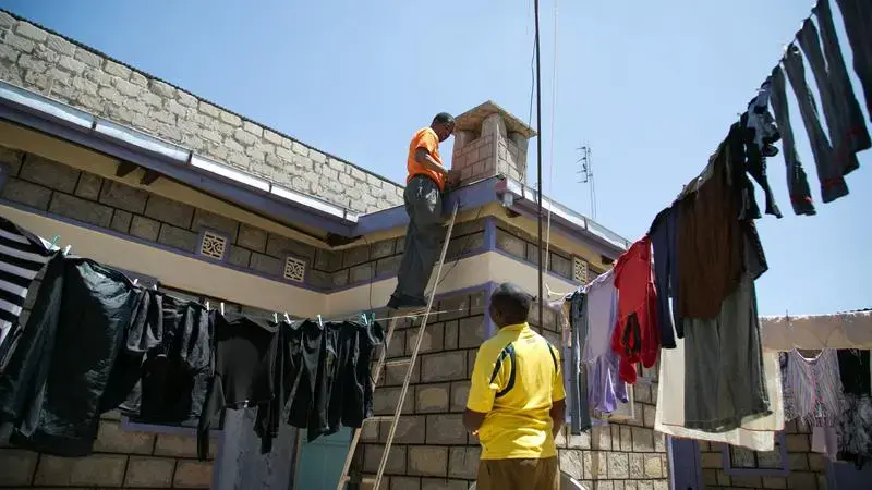 A StarTimes satellite dish is installed on Francis Gitonga's roof in Kajiado, Kenya. Gitonga said the new digital TV package, with Chinese and Kenyan programs, gave him better reception than he’d once thought possible in the town. Image by Immanuel Muasya. Kenya, 2017. 