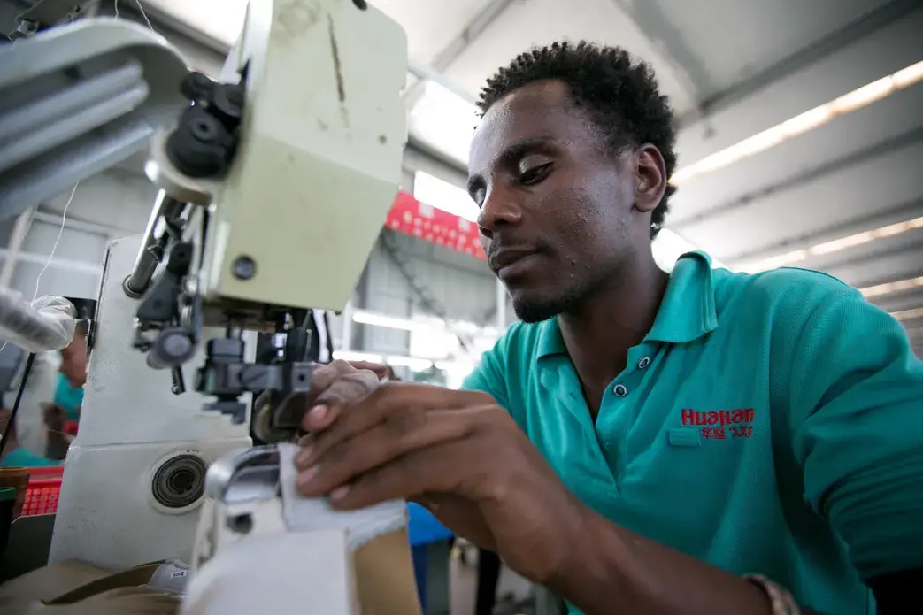 In the Chinese-owned Huajian Shoe Co. Factory in Addis Ababa, more than 6,000 workers build shoes for American brands such Tommy, Guess and Lucky. Image by Noah Fowler. Ethiopia, 2017. In the Chinese-owned Huajian Shoe Co. Factory in Addis Ababa, more than 6,000 workers build shoes for American brands such Tommy, Guess and Lucky. Image by Noah Fowler. Ethiopia, 2017.