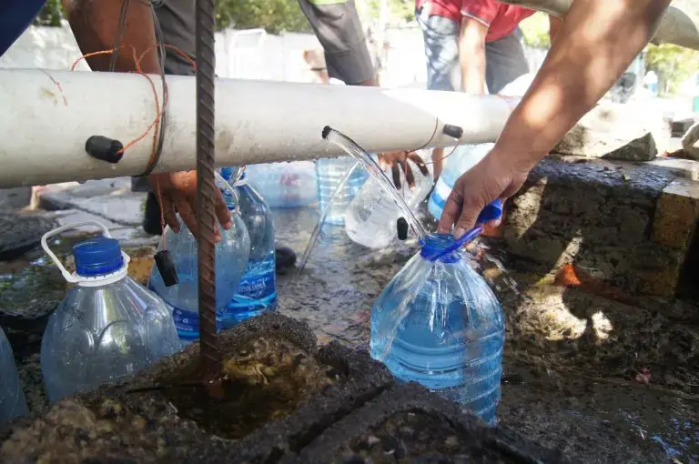 Residents collect water from a makeshift and unregulated water source at Springs Way. Image by Jacqueline Flynn. South Africa, 2018. Residents collect water from a makeshift and unregulated water source at Springs Way. Image by Jacqueline Flynn. South Africa, 2018.