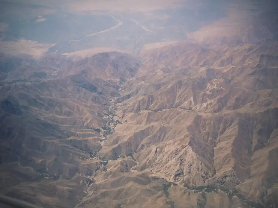 Afghanistan's peaks and valleys can be seen from 20,000 feet above the war-torn country. Image by Meghan Dhaliwal. Afghanistan, 2014. Media file: afghan1md.jpg