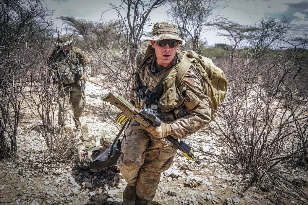 Paratroopers assigned to the 1st Battalion, 508th Parachute Infantry Regiment, 3rd Brigade Combat Team, 82nd Airborne Division provide emergency medical care to a simulated casualty during a live-fire exercise alongside British paratroopers from 2 PARA. Image courtesy of the U.S. military's press photos. Kenya, 2018.