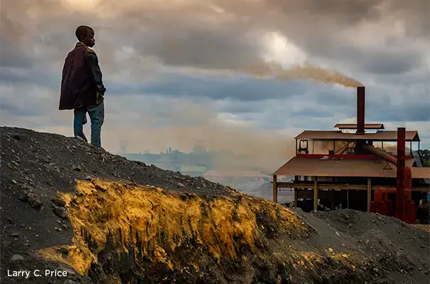 Children work among adults in this area at the base of an operating manganese reprocessing smelter managed by the Chinese company Super Deal. The smelter burns lead and manganese slag and spews toxic fumes across the Kabwe area. Image by Larry C. Price. Zambia, 2017.