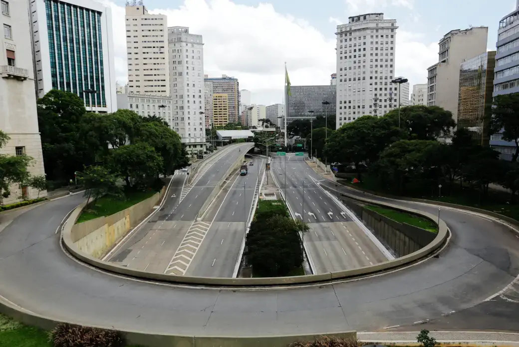 An empty street and avenue are seen in downtown São Paulo due to coronavirus outbreak. Image by Nelson Antoine / Shutterstock. Brazil, 2020. An empty street and avenue are seen in downtown São Paulo due to coronavirus outbreak. Image by Nelson Antoine / Shutterstock. Brazil, 2020.