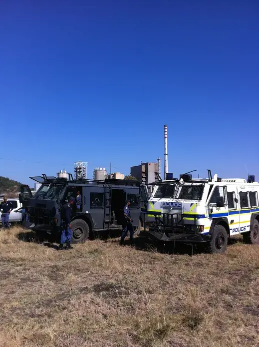 Police 'hippos' take up positions in the scrubland between Nkaneng settlement and the Lonmin mine, as South Africa's longest strike action comes to a head. Image by Jason Larkin. South Africa, 2014. Media file: marikanalarkin.jpg