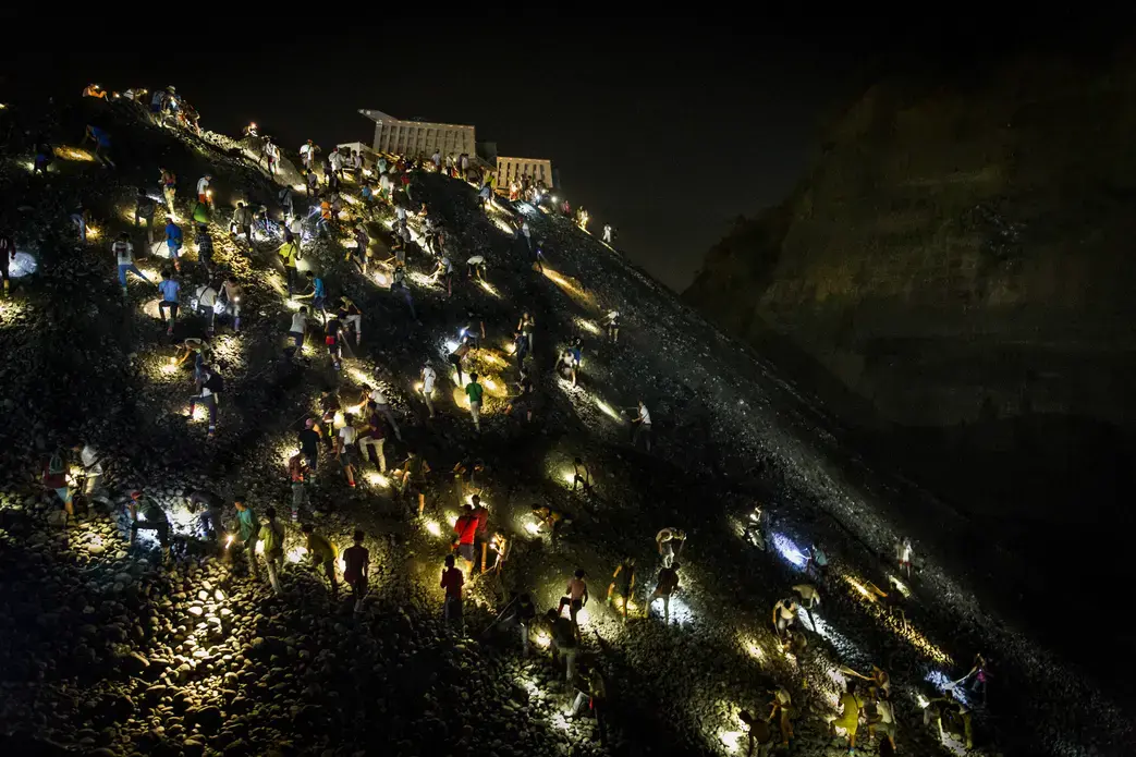 Freelance miners search for jade stones at night with torchlights on a waste site in Hpakant, Kachin State, Myanmar on May 21, 2019. Image by Hkun Lat. Myanmar, 2019. Freelance miners search for jade stones at night with torchlights on a waste site in Hpakant, Kachin State, Myanmar on May 21, 2019. Image by Hkun Lat. Myanmar, 2019.