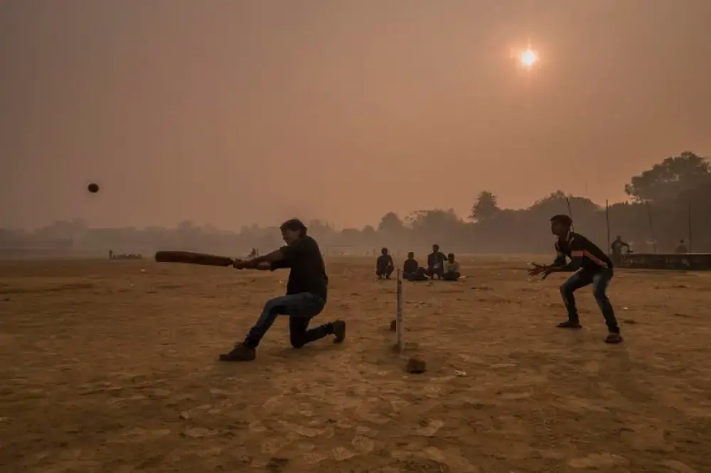 Surrounded by a thick layer of pollution that settled over Patna overnight, a dawn cricket match gets underway at Gandhi Maidan Park in central Patna. Image by Larry C. Price. India, 2018.