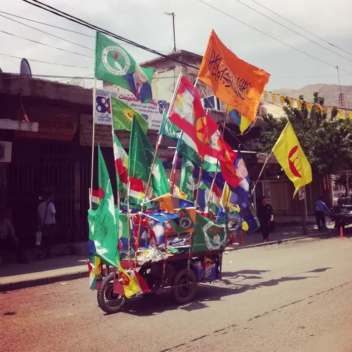 A vendor in Iraqi Kurdistan sells party flags in the heated months before Kurdish elections. Image by Jenna Krajeski. Iraq, 2014. Media file: img_1806.jpg