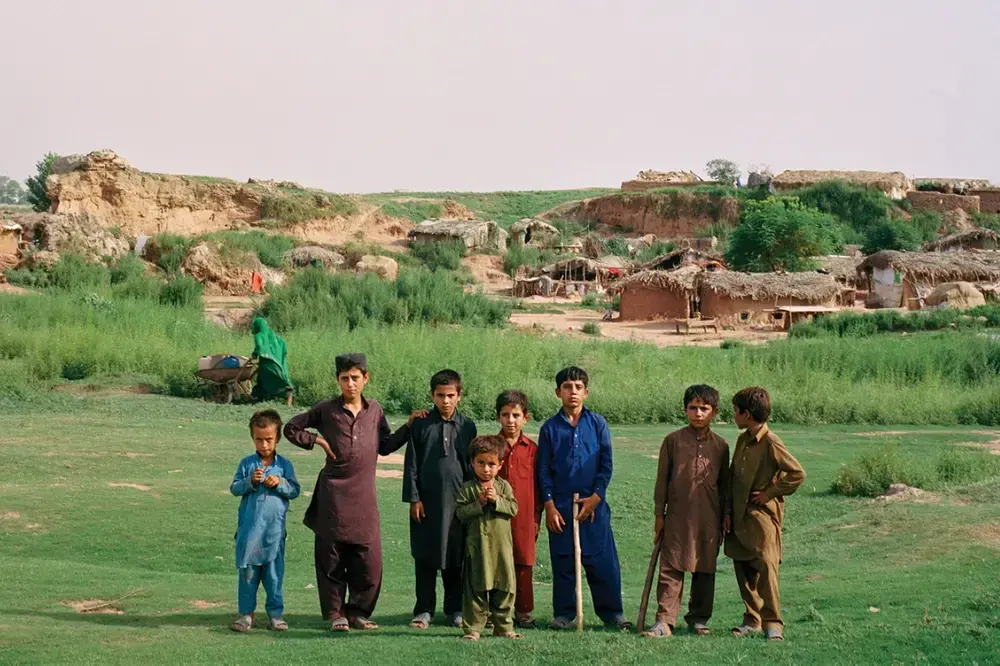 Young Afghan boys pose for a portrait on the outskirts of Islamabad. Sixty percent of Afghans in Pakistan are younger than 24. Image by Sara Hylton. Pakistan, 2019. Young Afghan boys pose for a portrait on the outskirts of Islamabad. Sixty percent of Afghans in Pakistan are younger than 24. Image by Sara Hylton. Pakistan, 2019.
