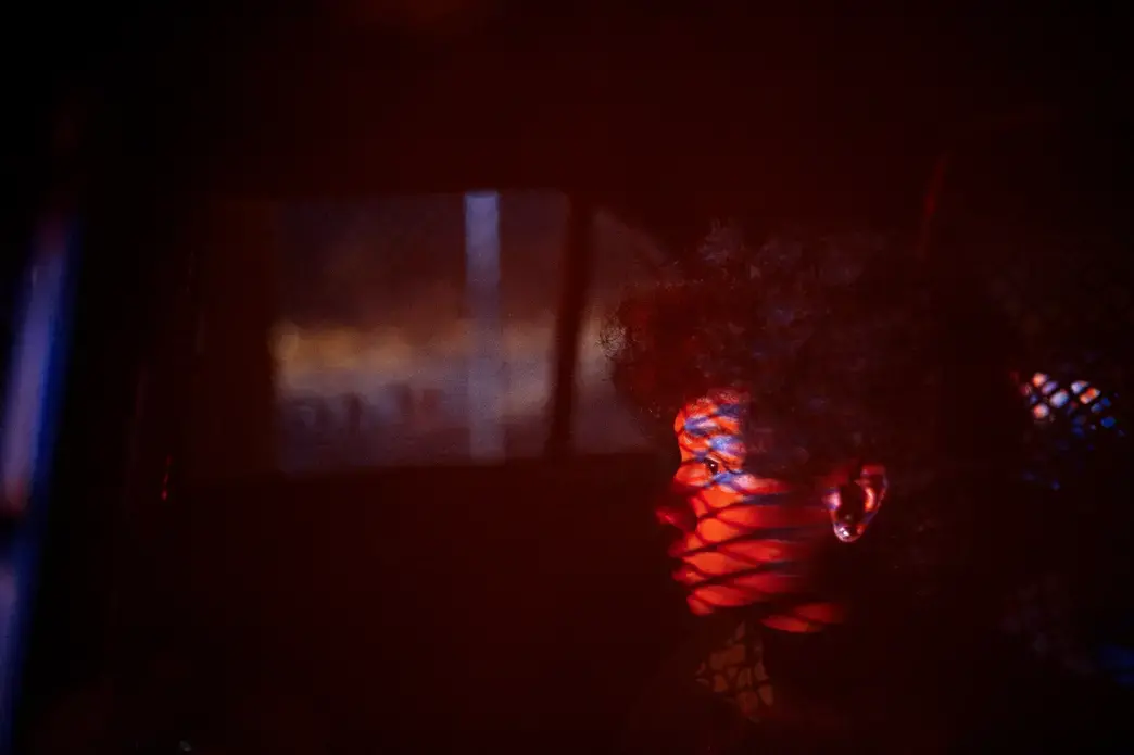 After leading the gang unit on a high speed car chase, a boy sits in custody while members of the unit chase his friends on foot through the neighborhood. No weapons or drugs were found on any of the boys and after investigating, none were members of a gang and they ran because they were afraid of police. Image by Brian L. Frank/2017 Catchlight Fellow. United States, 2018. After leading the gang unit on a high speed car chase, a boy sits in custody while members of the unit chase his friends on foot through the neighborhood. No weapons or drugs were found on any of the boys and after investigating, none were members of a gang and they ran because they were afraid of police. Image by Brian L. Frank/2017 Catchlight Fellow. United States, 2018.