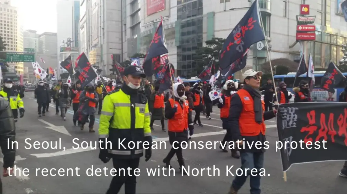 South Korean conservatives march through the streets of downtown Seoul in February 2018 to protest of their liberal president's diplomatic outreach to North Korea. Image by Rachel Oswald. South Korea, 2018.