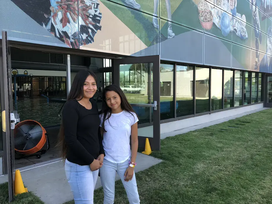 Destiny and Adrianna pose for a photo outside the East Oakland Sports Center. “I feel like we relate to each other,” Destiny says of her fellow campers. “It’s hard on all of us, but we just have to take care of one another while we’re here.” Image by Jaime Joyce for TIME Edge. California, 2018.