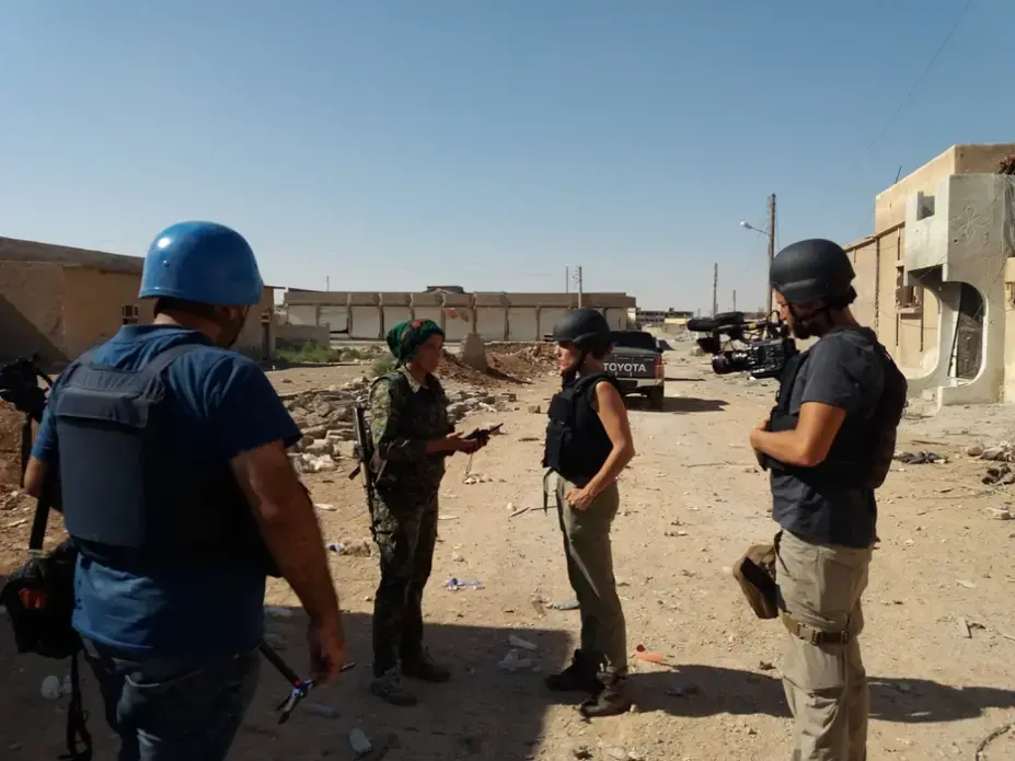 Klara, a Kurdish commander and leader of the battle to rout ISIS from Raqqa, shows us around the site of a still-smoking ISIS car bomb. Image by Jon Gerberg/PBS NewsHour. Syria, 2017.