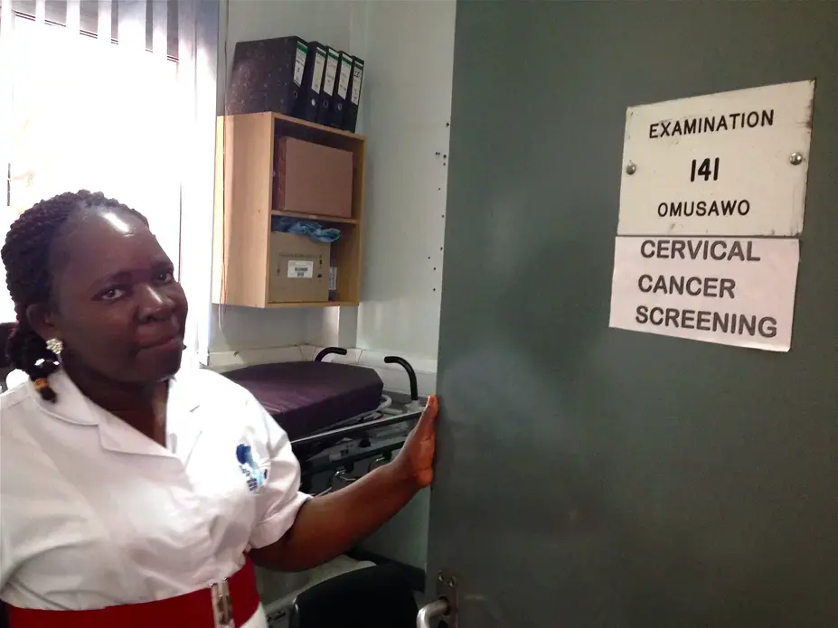 Nurse Josephine Nakajubi screens women for cervical cancer in an examination room located within an HIV clinic in Kampala, Uganda. Image by Sascha Garrey. Uganda, 2014. Media file: untold_story_2_-_nurse_josephine.jpg