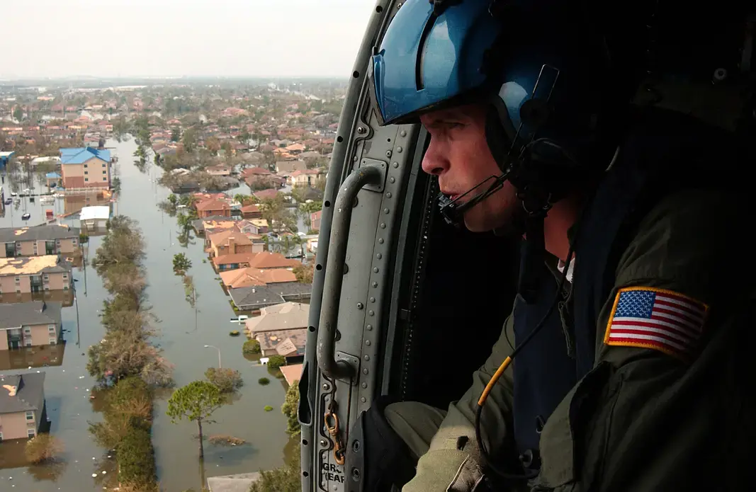 Coast Guard Petty Officer 2nd Class Shawn Beaty, 29, of Long Island, N.Y., looks for survivors in the wake of Hurricane Katrina, New Orleans, 2005