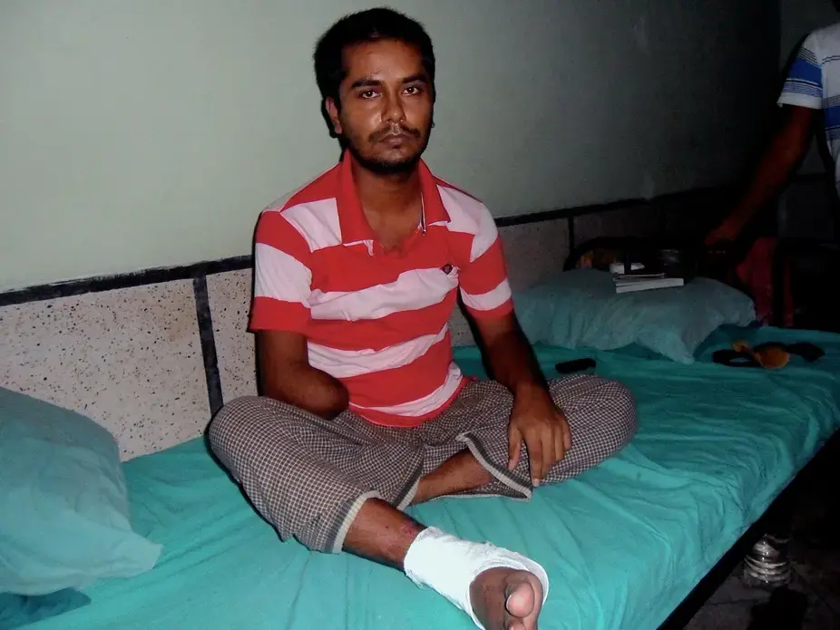 Rana Plaza survivor Saddam Hossain recovers in a hospital after the building collapse claimed part of his right arm. Image by Golam Mortuja. Bangladesh, 2016. Rana Plaza survivor Saddam Hossain recovers in a hospital after the building collapse claimed part of his right arm. Image by Golam Mortuja. Bangladesh, 2016.
