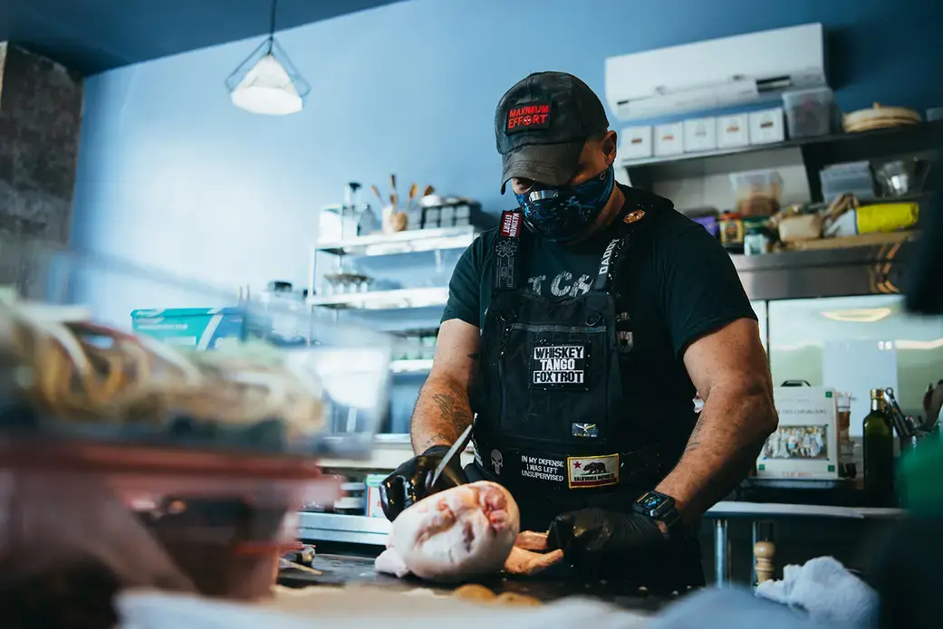Chef Russell Jackson prepares food for takeout at Reverence, his fine dining restaurant in Harlem. Image by Cassie Zhang / Zagat. United States, 2020. A chef prepares food for takeout at Reverence, a fine dining restaurant in Harlem.