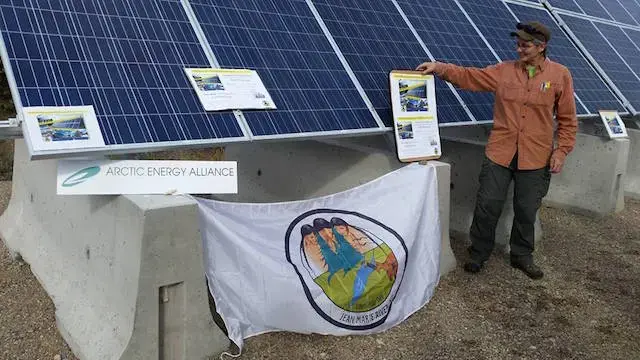 Teresa Chilkowich, of Arctic Energy Alliance, in front of the new solar panel in Jean Marie River. Image by Jean Marie River First Nation. Canada, 2016.