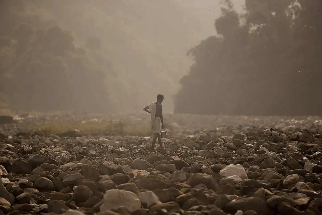 A man finds a spot to bathe along the banks of the Sapta Kosi River in Baha Chhetra. Image by Steve Matzker. Nepal, 2013. Media file: nepal_untold_002.jpg