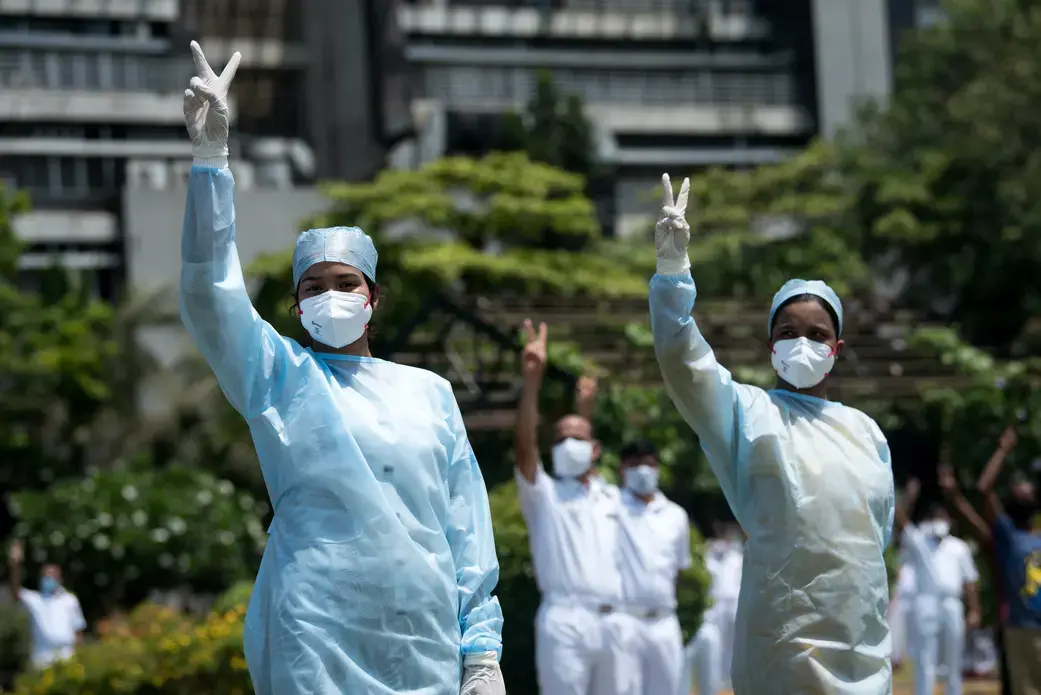 Hospital staff in Mumbai pay tribute to those involved in the fight against the spread of the coronavirus. Image by Manoej Paateel/Shutterstock. India, 2020. Hospital staff in Mumbai pay tribute to those involved in the fight against the spread of the coronavirus. Image by Manoej Paateel/Shutterstock. India, 2020.