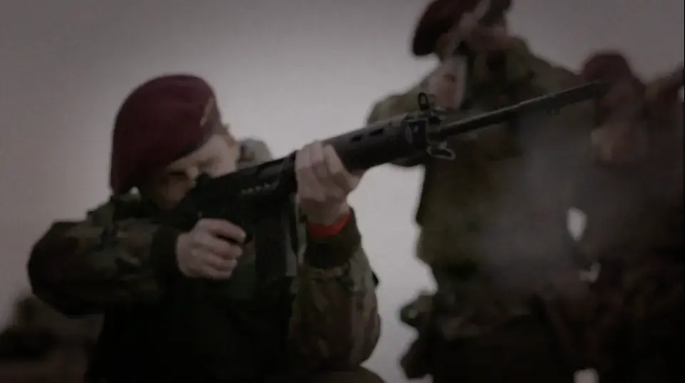 A soldier shoots a gun during a scene in The Ballymurphy Precedent trailer. Image courtesy of Dartmouth Films. Ireland, 2018.