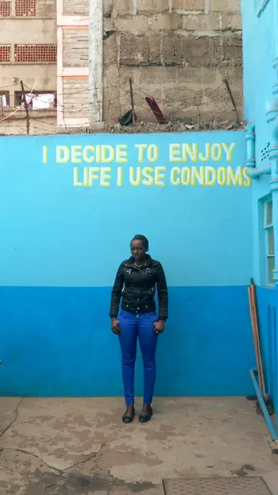 Josephine Kimani, 24, stands inside the Family Health Options Kenya Youth Center in Eastleigh. Image by Adiba Khan. Kenya, 2014. Media file: photo_main_article_khan.jpg