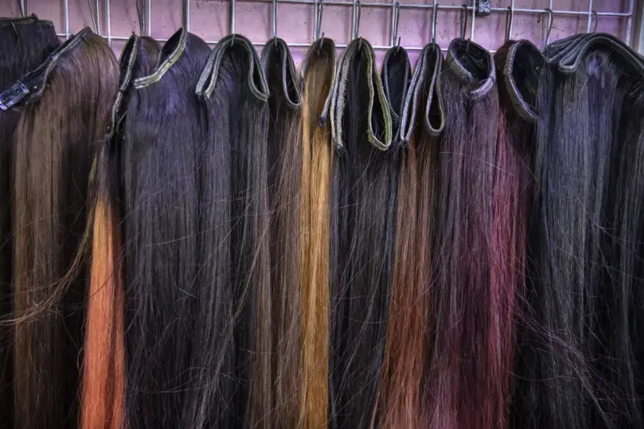 Hair pieces on display at a salon in Phnom Penh. Image by Paula Bronstein. Cambodia, 2019.