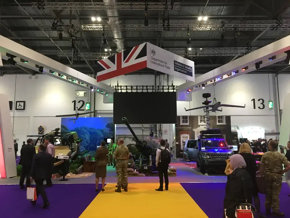 The British quarter at the world's largest arms fair, DSEI in London. The Defence &amp; Security Organisation, a taxpayer funded organ of the UK government, has its logo raised high - it ploughs significant sums into promoting British arms companies exports around the world, including organising arms fairs. Image by Matt Kennard. United Kingdom, 2017. 
