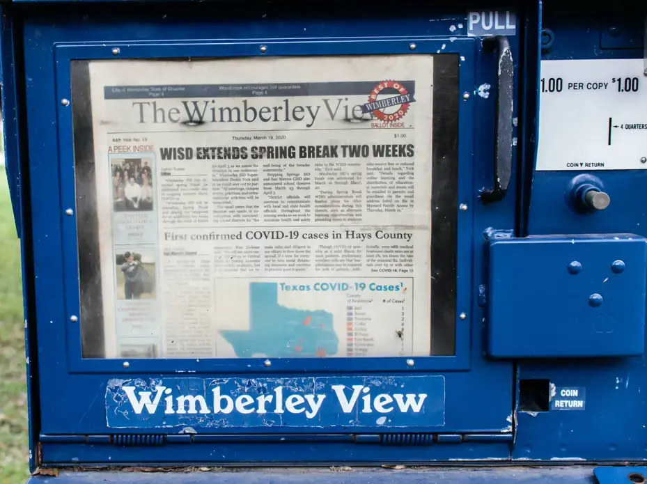 The Wimberley View of Wimberley, Texas is sold in a newspaper stand. Image by Kristin Taibi / Shutterstock. United States, 2020. Media file: shutterstock_1676631235_copy.jpg