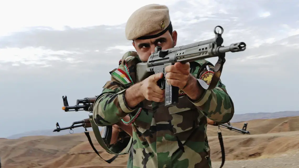 A Kurdish peshmerga soldier takes the lead during urban combat maneuvering training held near Erbil. Image by Spc. Tristan Bolden / U.S. Army. Iraq, 2015.