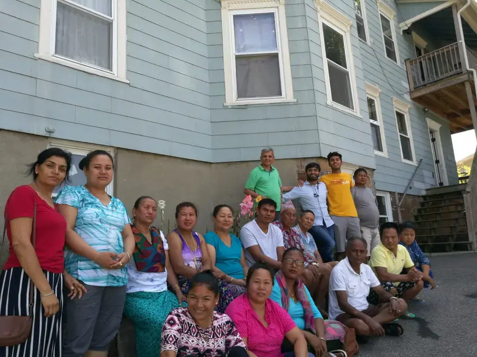 A group of Bhutanese refugees residing in the greater Worcester area with Purna Neupane (fourth from right), Harvard Medical School researcher Dr. Nadeem Kasmani (third from right), and Washington University in St. Louis student Ani Gururaj (second from right). Image courtesy of Ani Gururaj. Massachusetts, 2018. A group of Bhutanese refugees residing in the greater Worcester area with Purna Neupane (fourth from right), Harvard Medical School researcher Dr. Nadeem Kasmani (third from right), and Washington University in St. Louis student Ani Gururaj (second from right). Image courtesy of Ani Gururaj. Massachusetts, 2018.