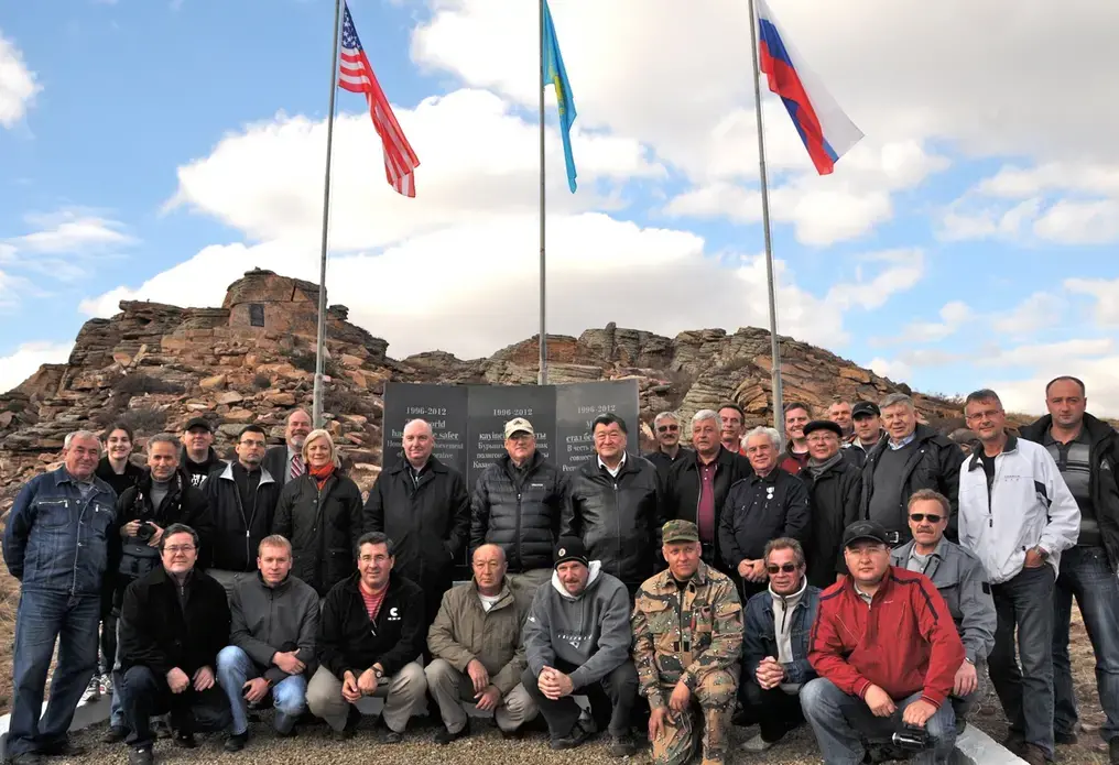 Scientists celebrate on top of the mountain. Image courtesy of US Department of Defense. Kazakhstan, 2013. Media file: weber_a_vip_tour_129.jpg