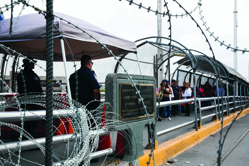 Razor wire is strung along the U.S. and Mexico sides of a port of entry in El Paso, Texas. Image by Jinitzail Hernández. United States, 2019.