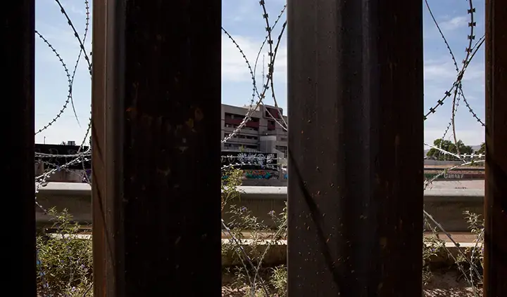 Razor wire supplements the border fence in El Paso, Texas on Aug. 23, 2019. Image by Jinitzail Hernández/CQ Roll Call. United States, 2019.