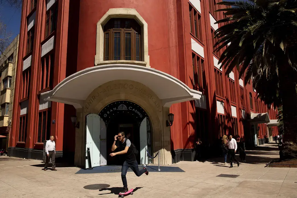 A skateboarder passes the Gran Casino, near the Monumento a la Revolución. Image by Erika Schultz. Mexico, 2019.