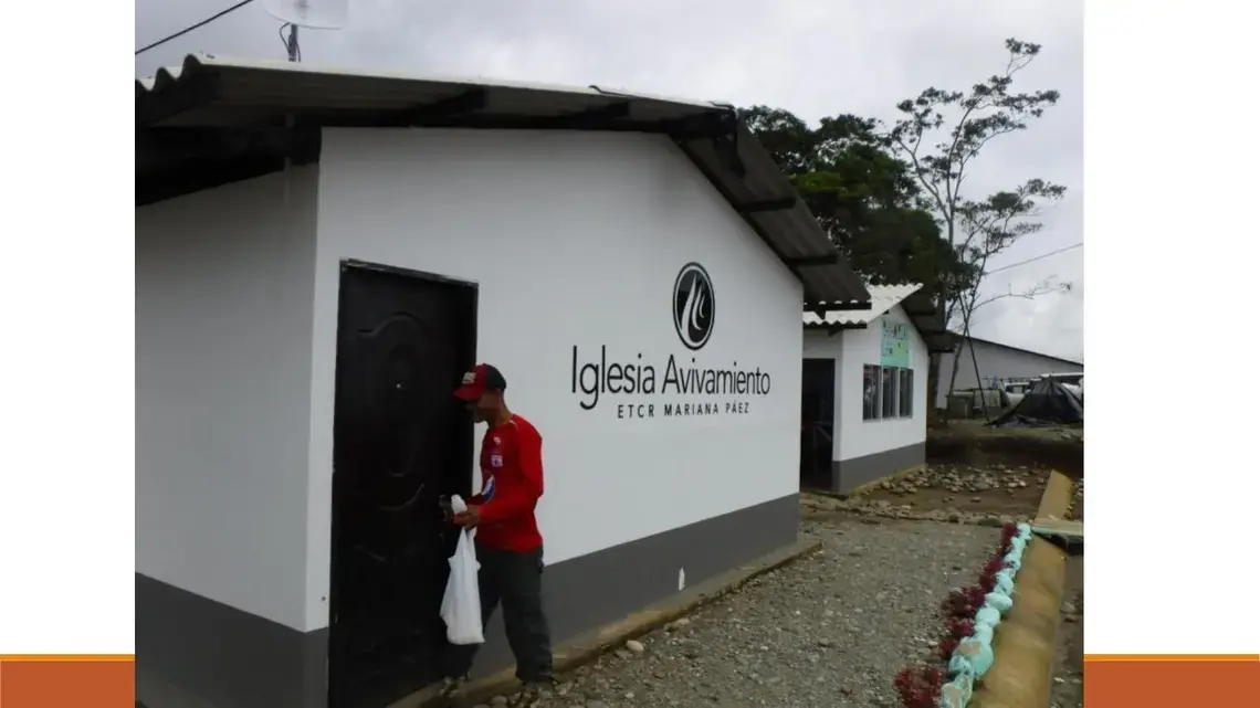 Eder Caicedo Cristian unlocks the community church in the FARC transition zone Mariana Paez. The church is one of five built by Avivamiento, a Bogotá-based evangelical church. Image by Julia Friedmann. Colombia, 2018.