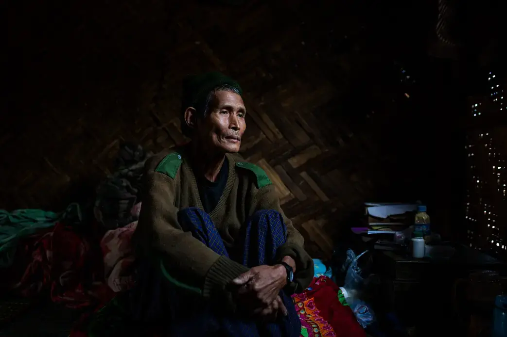 Dawng Hkawng, who was displaced by the Chipwi dam project in 2012, sits in his small room in the Chipwi internally displaced persons camp in Chipwi, Kachin State, Myanmar. Image by Hkun Lat. Myanmar, 2019. Dawng Hkawng, who was displaced by the Chipwi dam project in 2012, sits in his small room in the Chipwi internally displaced persons camp in Chipwi, Kachin State, Myanmar. Image by Hkun Lat. Myanmar, 2019.